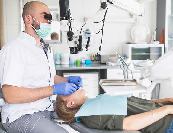 dentist performing a root canal treatment
