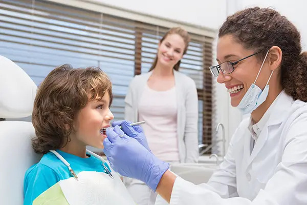 Family dentistry specialist examines child's teeth