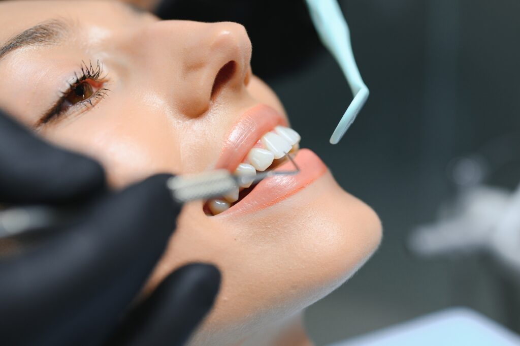 Headshot of a woman having a dental cleaning.