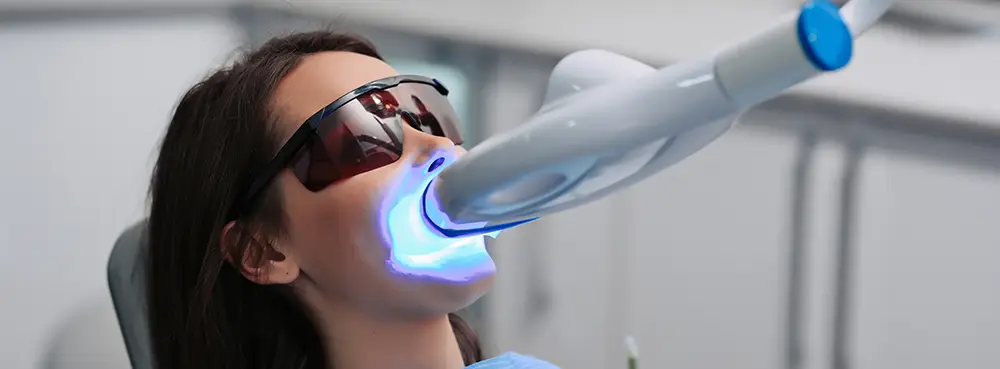 Woman getting professional teeth whitening services