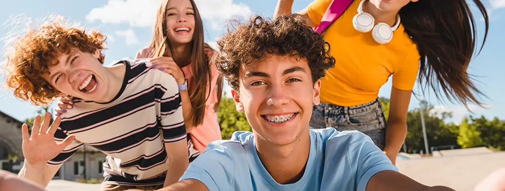 Teenager with Fastbraces handing out with friends