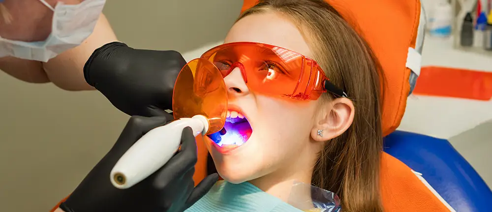 teen girl with cavities getting a dental filling