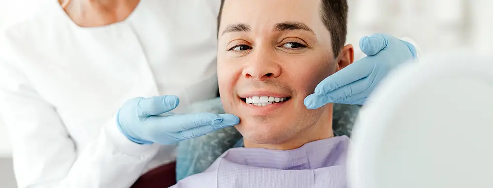 Man with perfect smile after Invisalign treatment