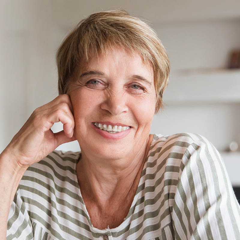 Older woman smiling with ceramic braces