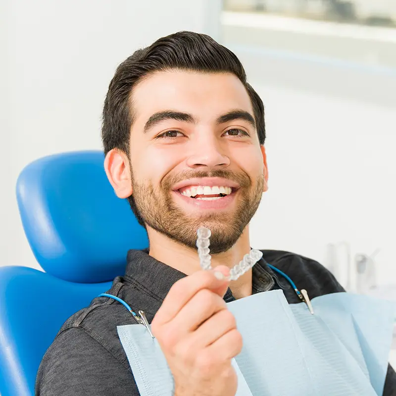 Young man holding up Invisalign