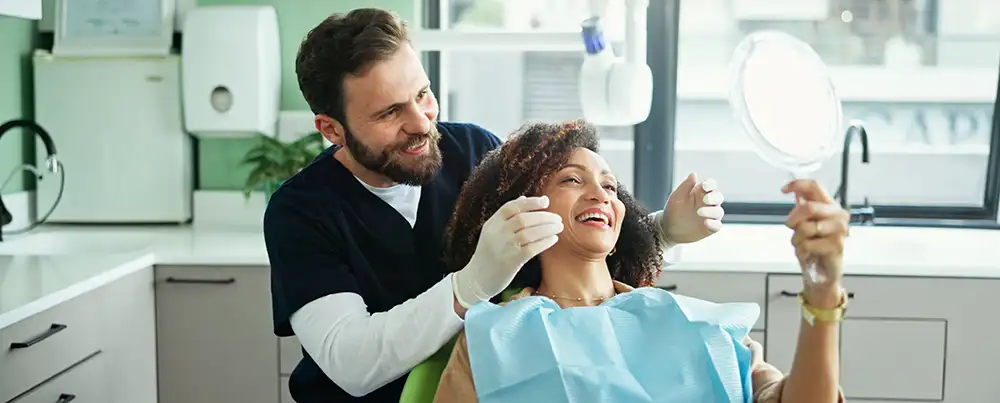 Woman smiling after dental cleaning and dental exam