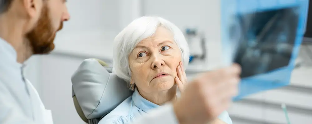 older woman with tooth ache needing root canal