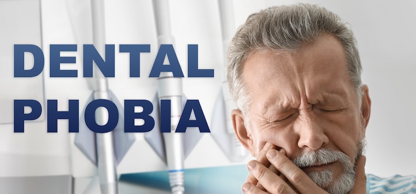 A middle-aged man winces and holds his jaw in pain in a dental office setting beside bold text reading Dental Phobia directly representing the fear and anxiety that prevent many patients from seeking necessary dental care in Virginia.