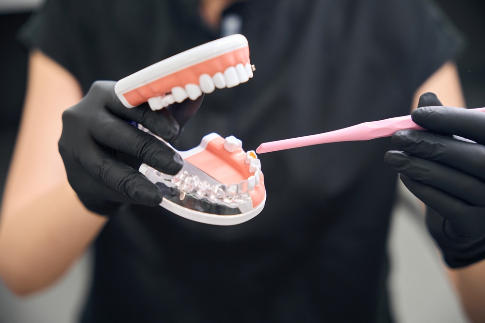 Dental technician using 3d model to show to client destroyed teeth