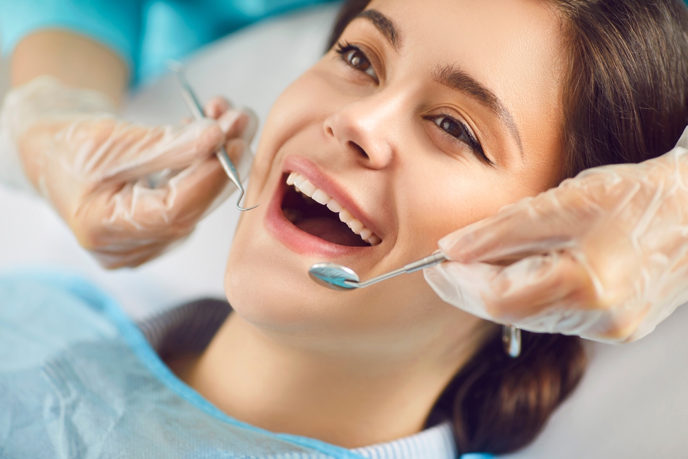 Dentist doctor performing dental therapy on a patient using an instrument in a clinic. This care session highlights the importance of professional medicare in maintaining oral health.
