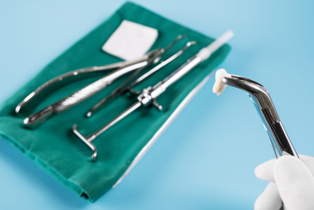  Dentistry medical tools forcept upper and lower on blue background.