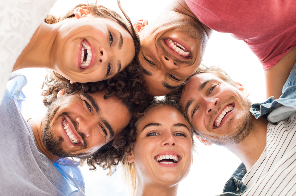 Healthy smiles after moderate periodontitis treatment at The Foleck Center in Virginia Beach, Norfolk, and Hampton Group of smiling adults with healthy teeth, representing gum disease prevention at The Foleck Center in Hampton Roads