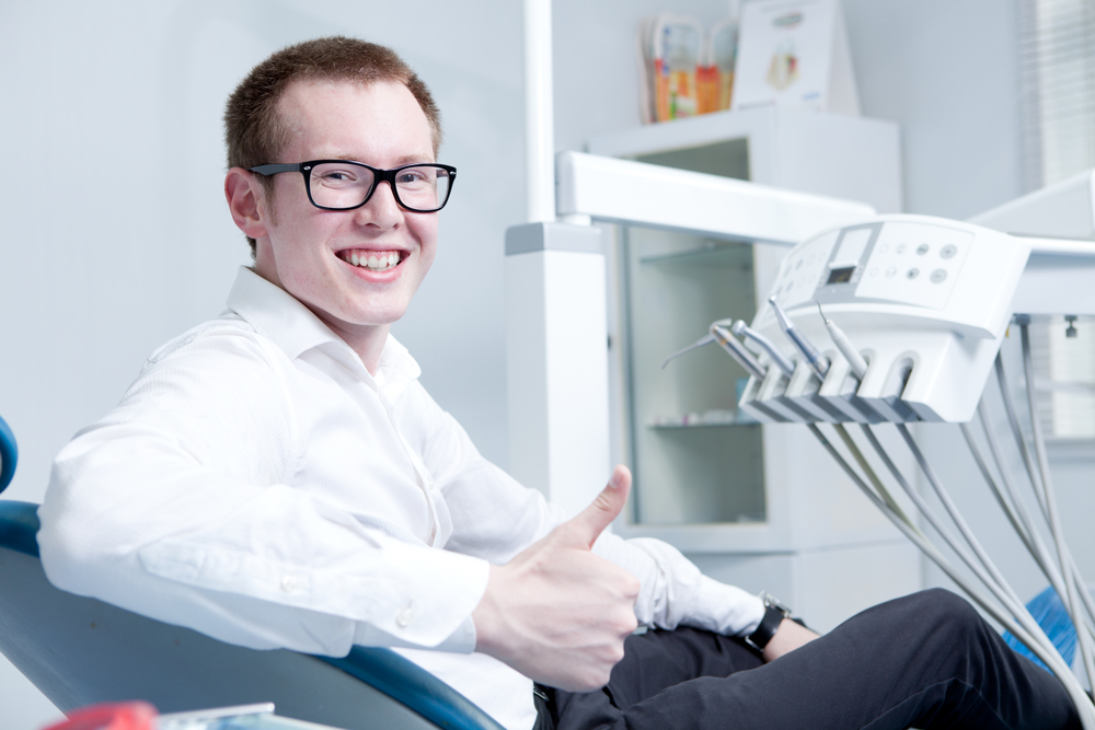 Happy patient at dentist office