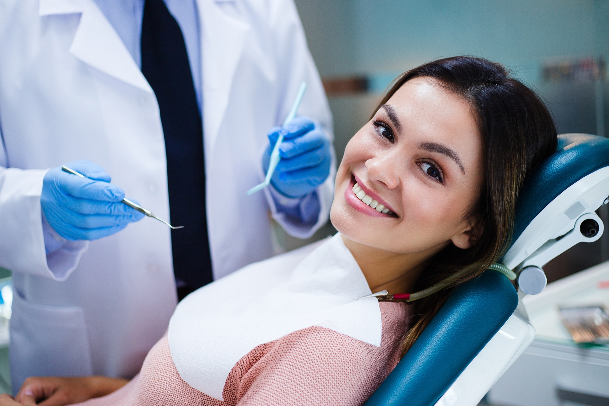 Dentures and partials consultation in Virginia Beach, VA, The Foleck Center Smiling woman in the dental chair during a dentures and partials consultation at The Foleck Center, Virginia Beach, VA