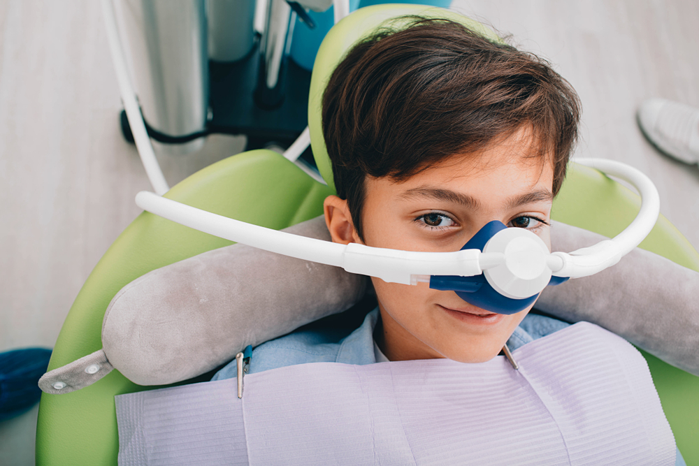 Young boy receiving nitrous oxide inhalation sedation during a teeth treatment in Norfolk 