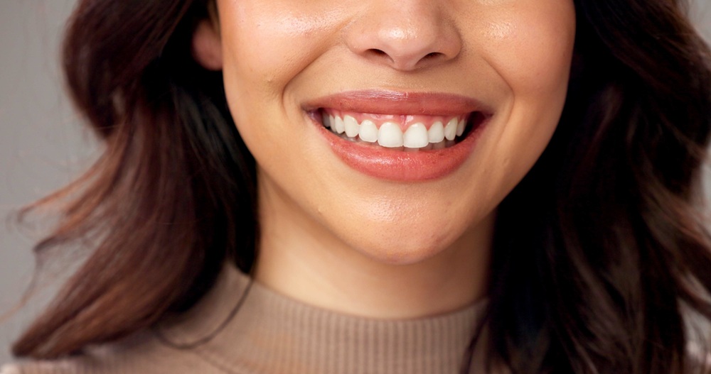 Cosmetic dental procedures in Hampton Roads Close-up of a woman's smile showing straight, white teeth