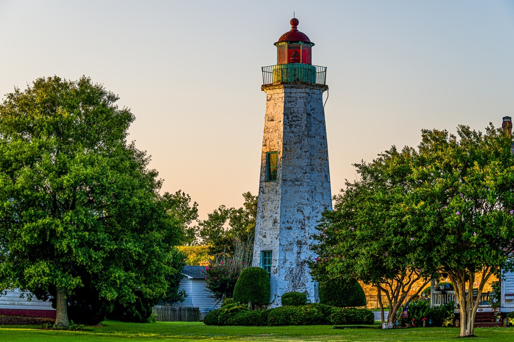 Fort Monroe landmark: Old Point Comfort Lighthouse near Kecoughtan Road Old Point Comfort Lighthouse surrounded by trees at Fort Monroe in Hampton, VA