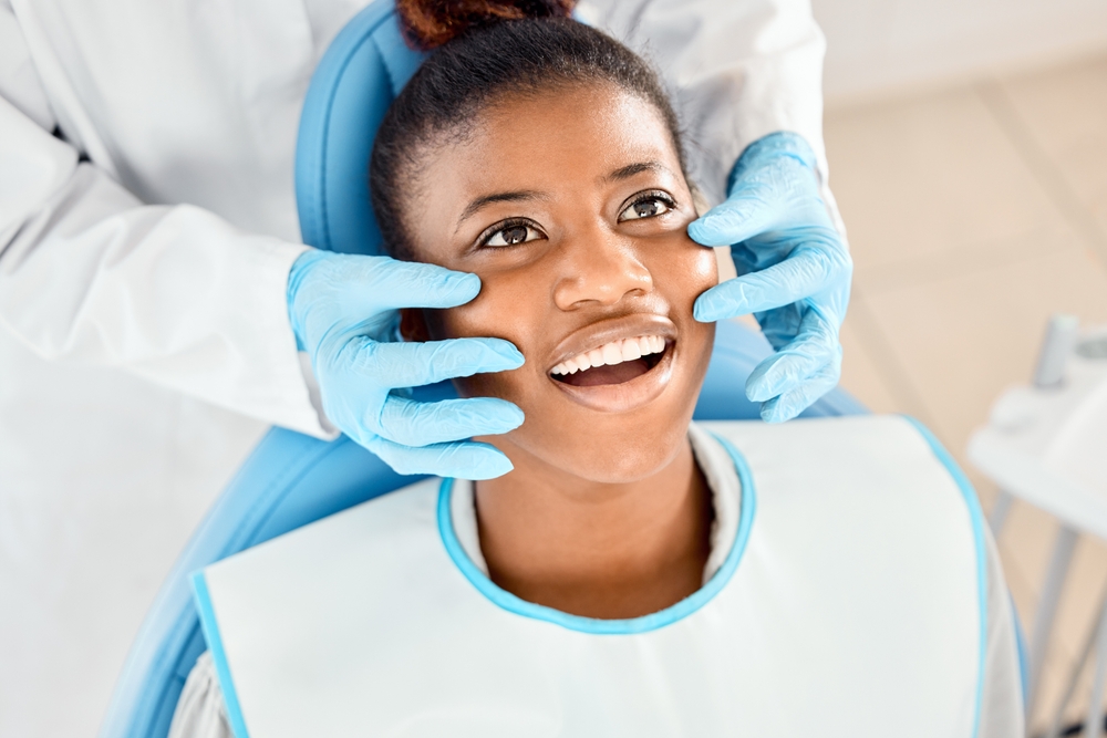 Oral, smile and woman with hands, dentist and happy for tooth health, healthcare and dental hygiene. Teeth, mouth and results for wellness of person, specialist and exam for treatment of patient