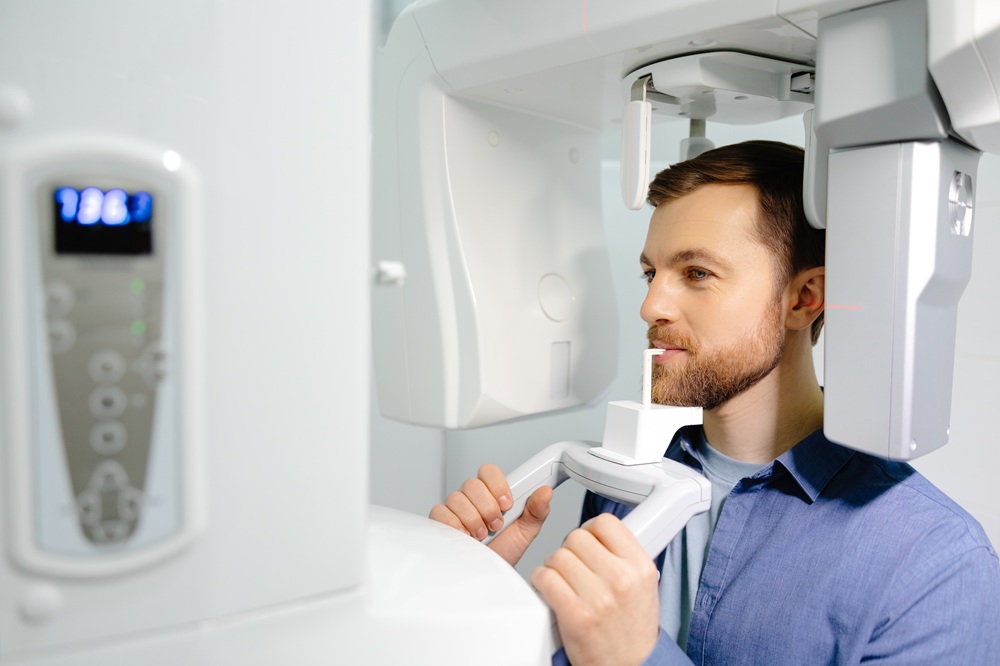 Man undergoing a panoramic dental X-ray 