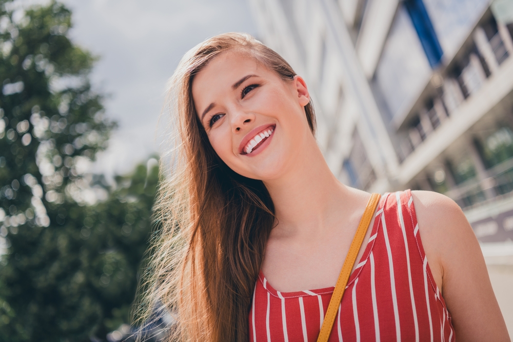 Photo of charming adorable positive girl wear trendy clothes walk alone big town summer sunny nice day outdoors