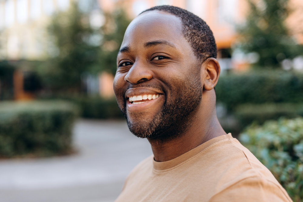 Healthy smile, general dentistry care in the Williamsburg community Man smiling broadly outdoors, healthy teeth from general dentistry care in the Williamsburg community