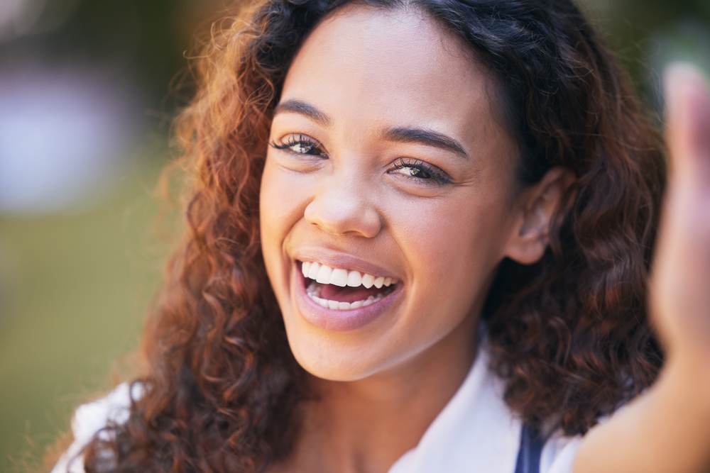 Smile, selfie and portrait of woman student in outdoor garden, park or field with positive attitude. Happy, pride and female person from Colombia with photography picture in nature for memory.