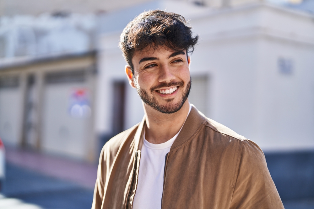 Smiling man with healthy teeth outdoors in the Hampton community 