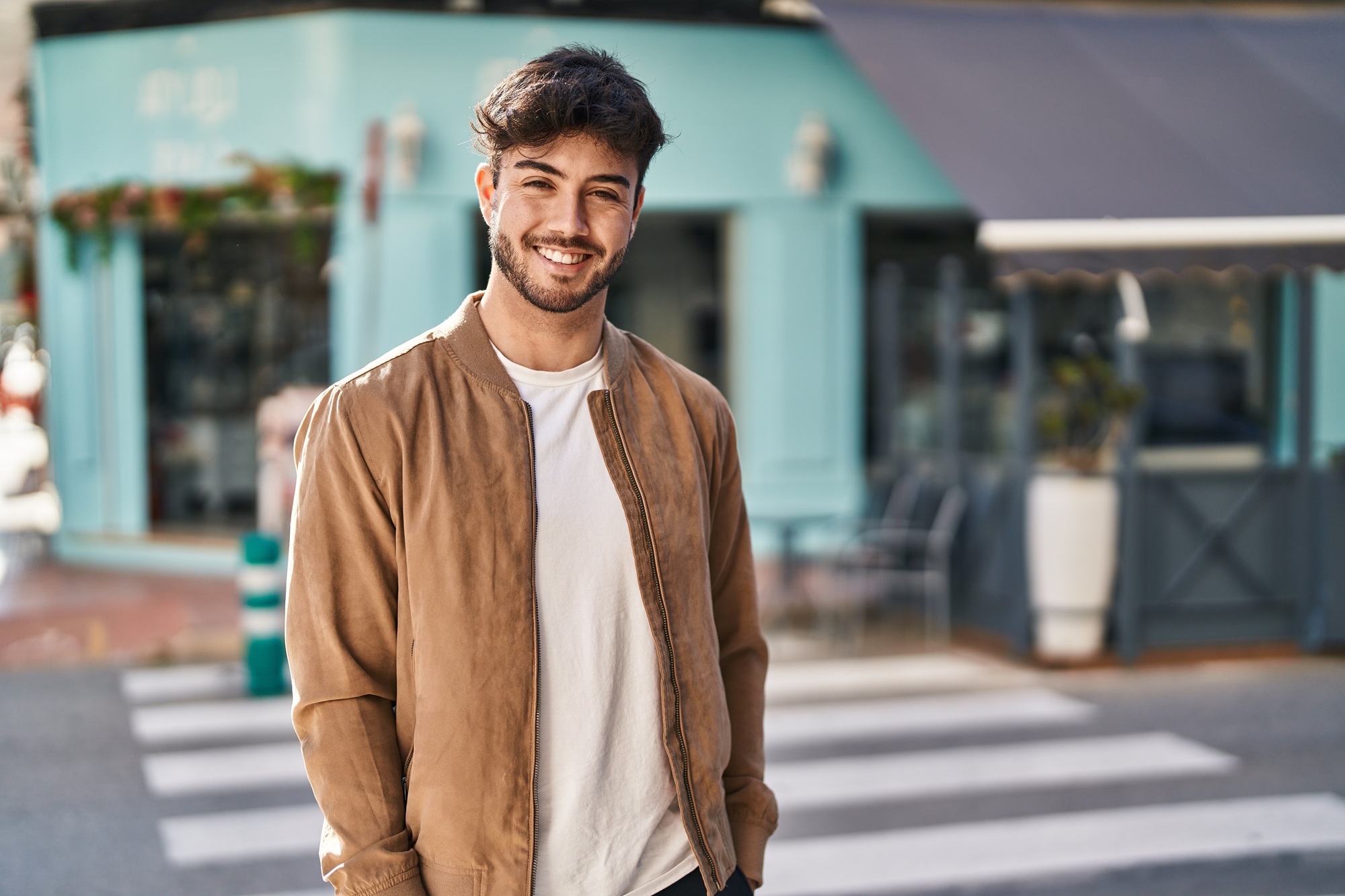 Confident smile: dental care in the Norfolk community Young man smiling confidently outdoors, representing the healthy smiles achieved in the Norfolk community