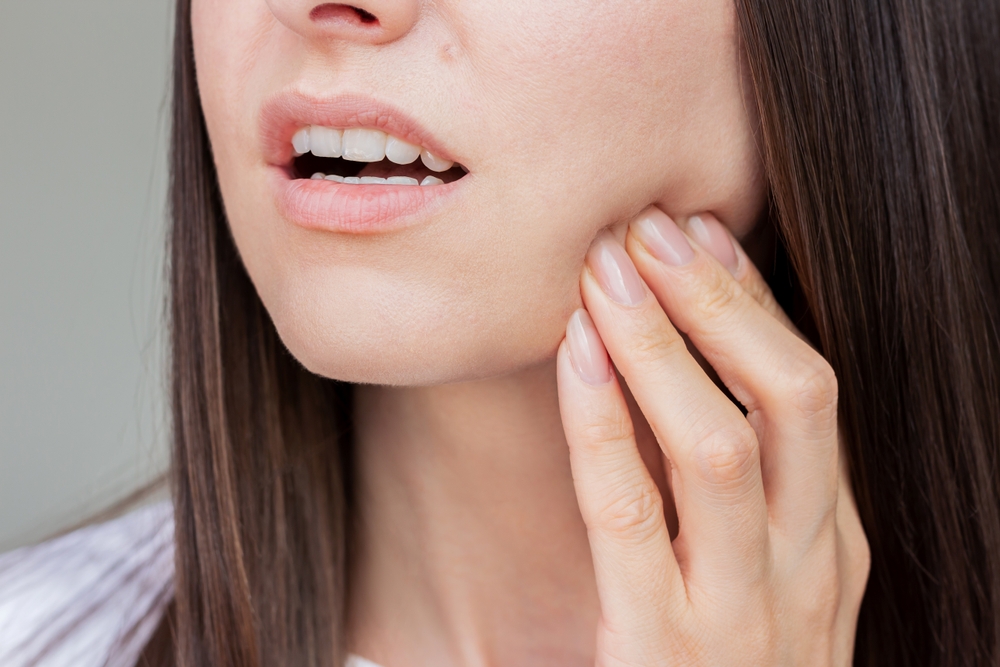 Young pretty caucasian woman suffering from gingivitis, gum inflammation, toothache. Dental care. Dentistry. Oral care