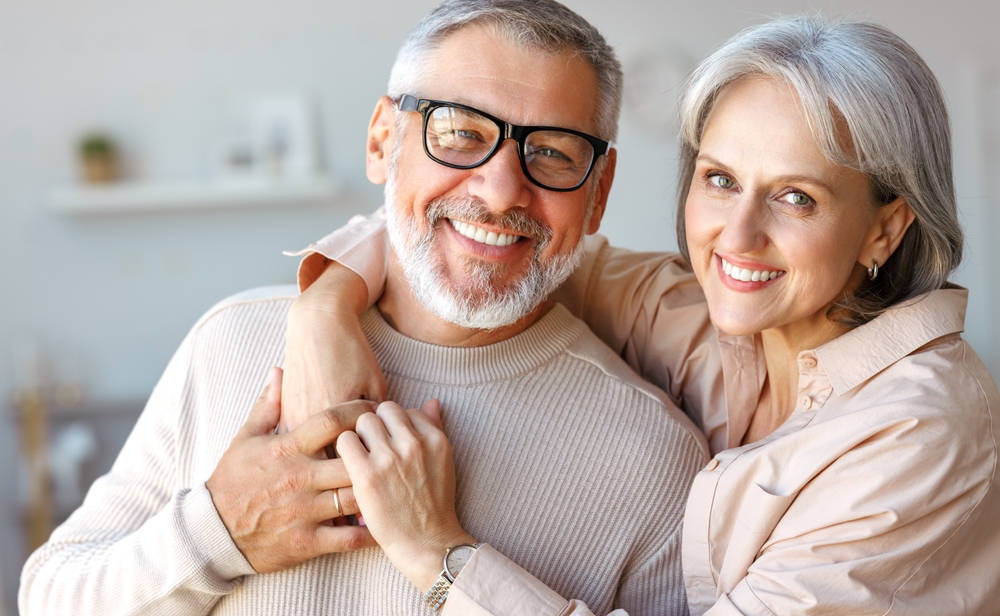 Smiling senior couple with bright, whitened teeth after a teeth whitening visit in Norfolk 