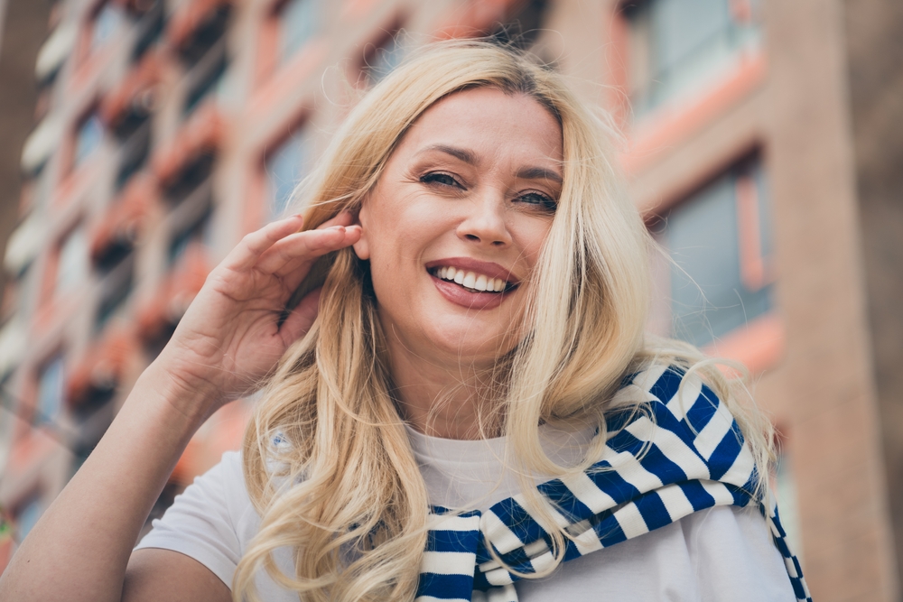 Smiling woman with healthy teeth outdoors in the Hampton community 