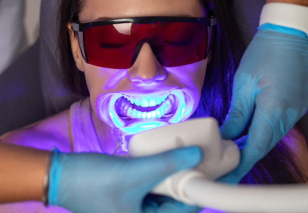 Patient undergoing an in-office LED teeth whitening treatment at a Hampton Roads dental office 