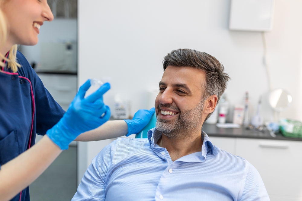 Invisalign consultation in Norfolk, VA, The Foleck Center Male patient smiling during an Invisalign consultation at The Foleck Center, Norfolk, VA
