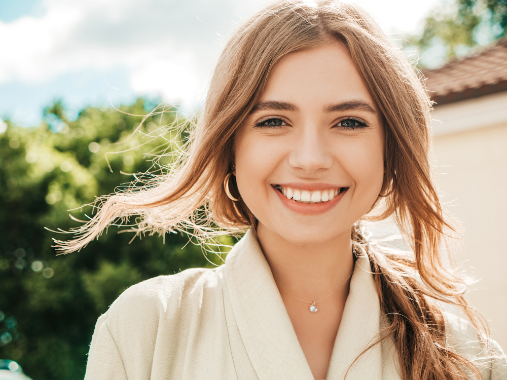 Woman with a healthy, bright smile outdoors in the Virginia Beach community 