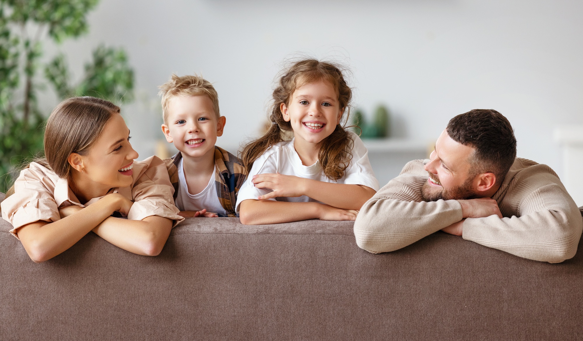 Family laughing together at home after a teeth whitening visit in the Norfolk community 