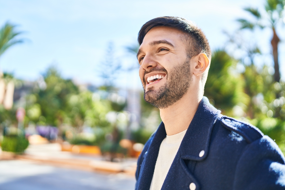 Man with a bright smile outdoors in the Hampton Roads area 