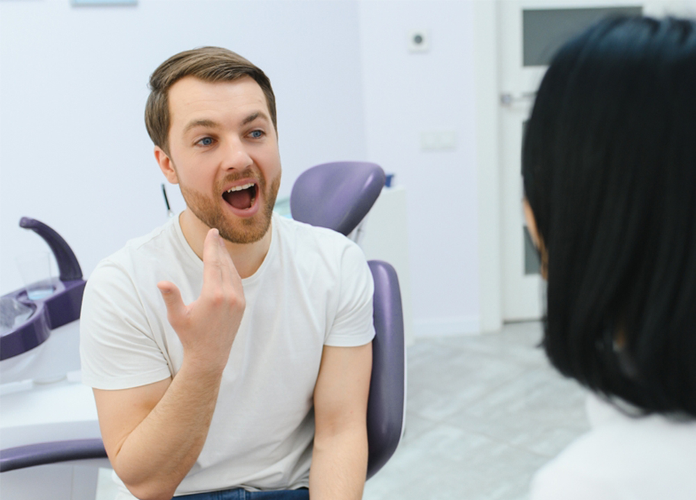 Patient speaking with his dentist during a visit at our Virginia Beach, VA office 