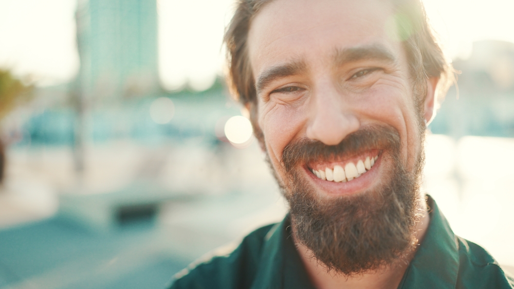 Confident smile outdoors in the Virginia Beach community Man with a healthy, bright smile outdoors in the Virginia Beach community