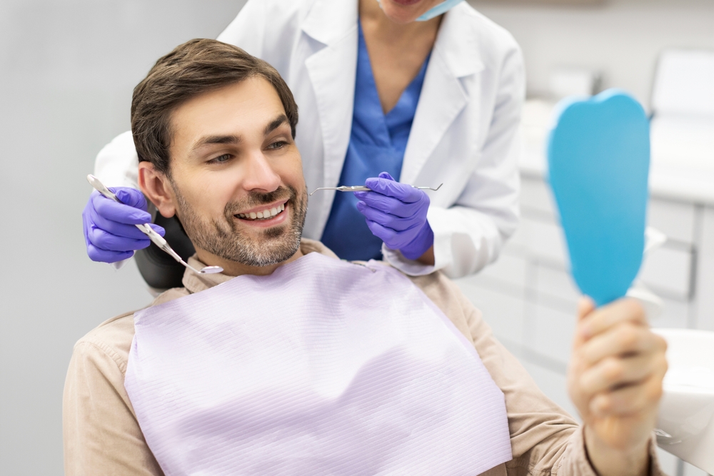 Patient reviewing his smile during a dental visit at our Virginia Beach, VA office 