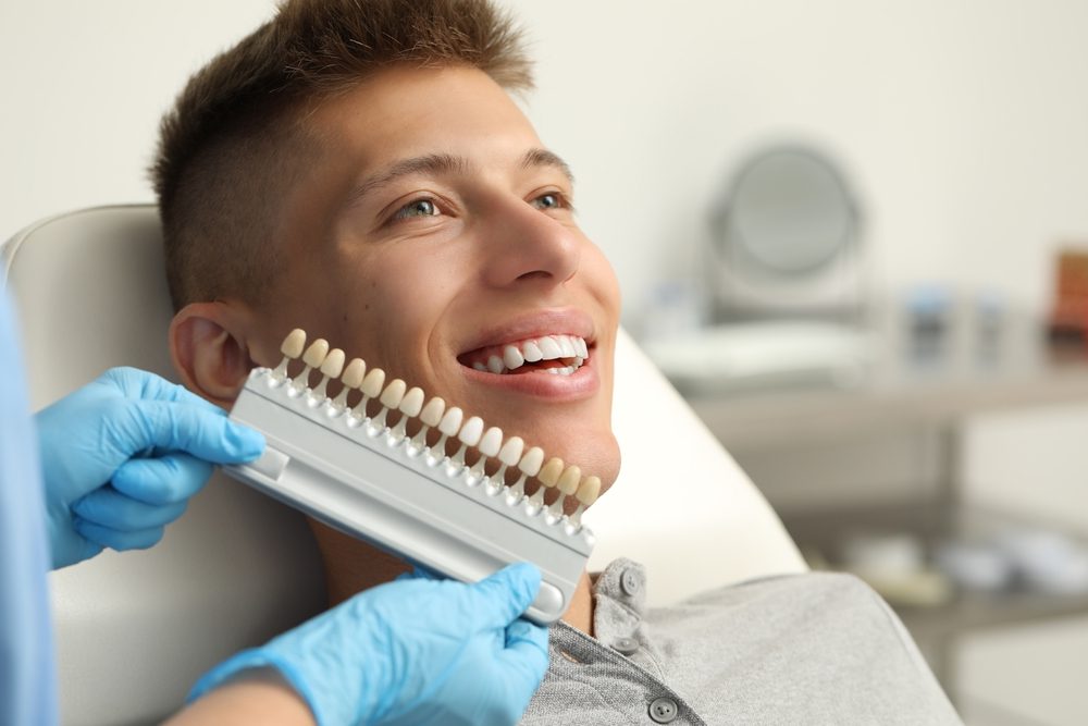 Father and son with beautiful smiles after cosmetic dental care at The Foleck Center, Virginia Beach