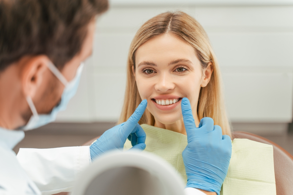 Dentist examining a patient's smile at our Hampton, VA office 