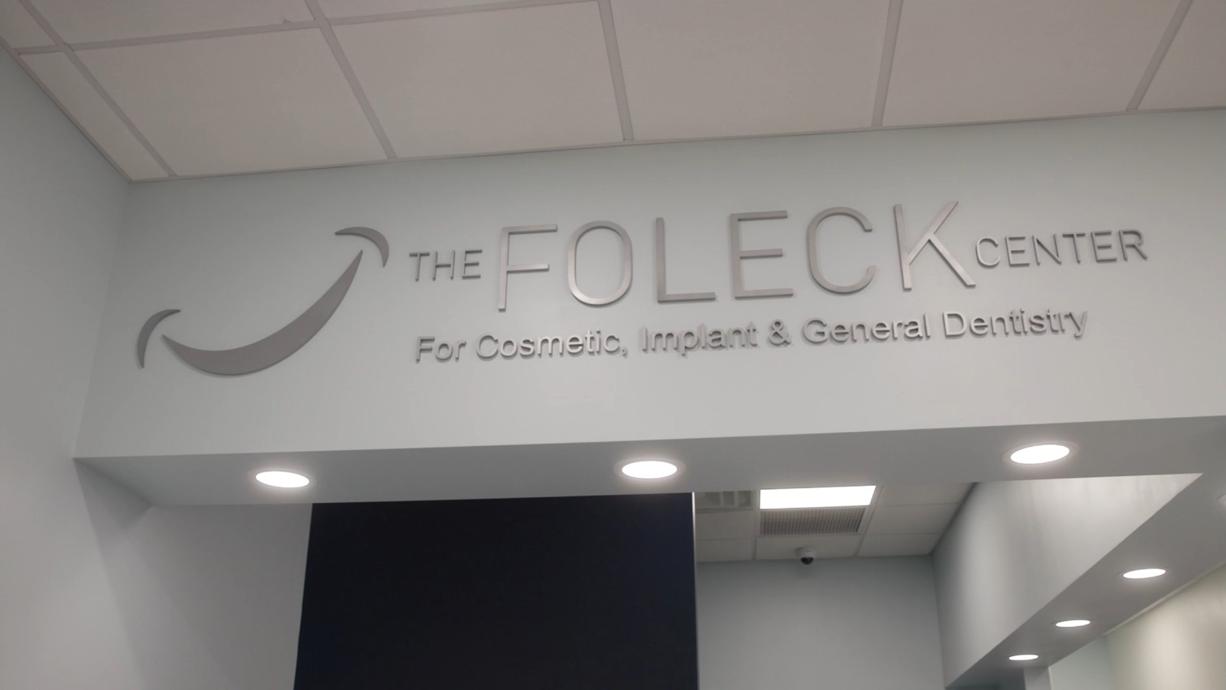 The Foleck Center lobby sign for cosmetic, implant, and general dentistry, Hampton Roads, VA